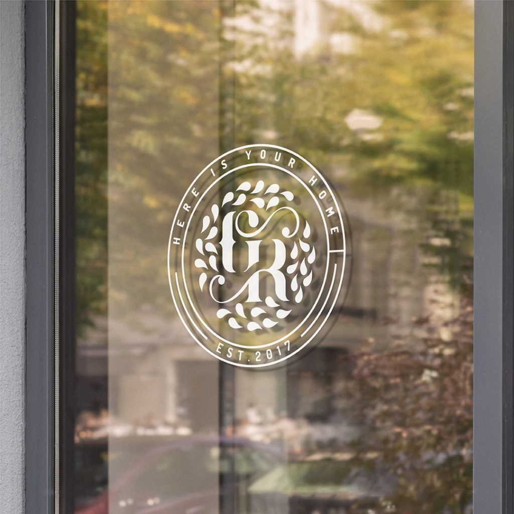 stick of logo design on the welcome door of a restaurant with images of local trees mirroring in the galss of the door